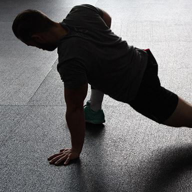 A man doing a side plank on the floor